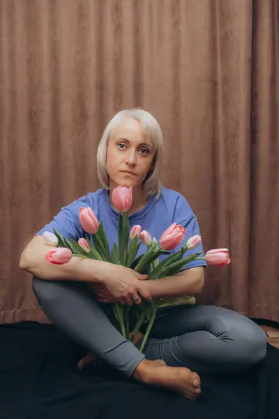 woman with tulips in hands