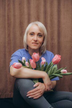 Elinde laleler olan bir kadın.