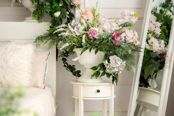 stock image flowers in a vase in a bright room with a bed