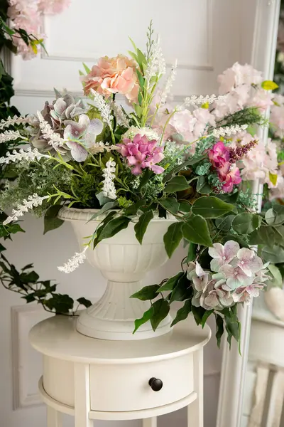 stock image flowers in a vase in a bright room with a bed