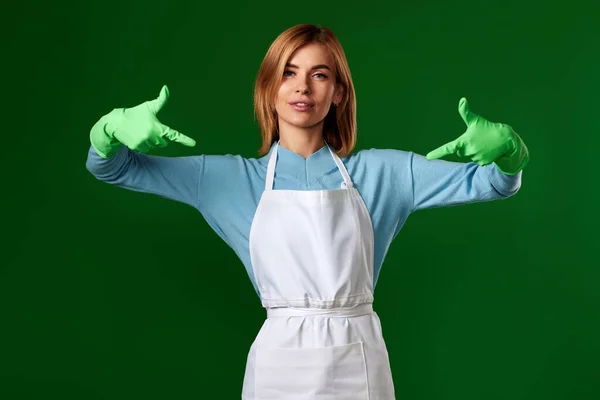 Attraktiv Blond Kvinna Handskar Pekar Sig Med Fingrar Grön Bakgrund — Stockfoto
