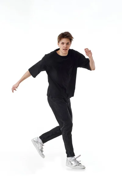 Glada Ung Man Svart Shirt Och Jeans Dansar Vit Bakgrund — Stockfoto