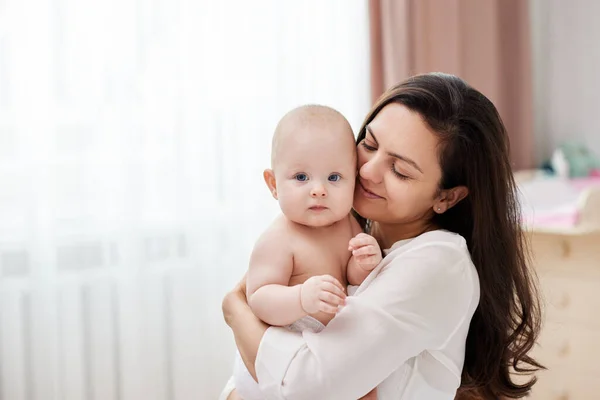 Happy Mother Holding Hugging Adorable Newborn Baby Home Window — Stock Photo, Image