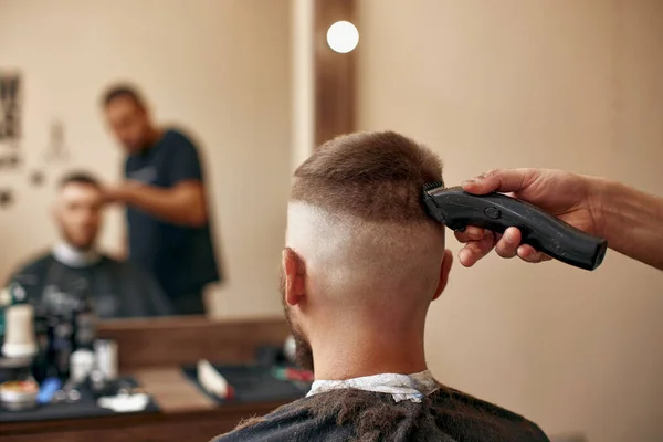 Widok Tyłu Fryzjer Wykończenie Włosy Obcinaczem Przystojnego Brodatego Mężczyzny Salonie — Zdjęcie stockowe
