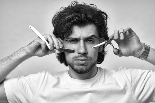 portrait of barber with sharp blade before cutting. black and white