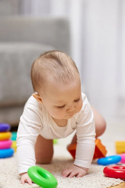 stock image cute baby girl playing with colorful toy blocks at home