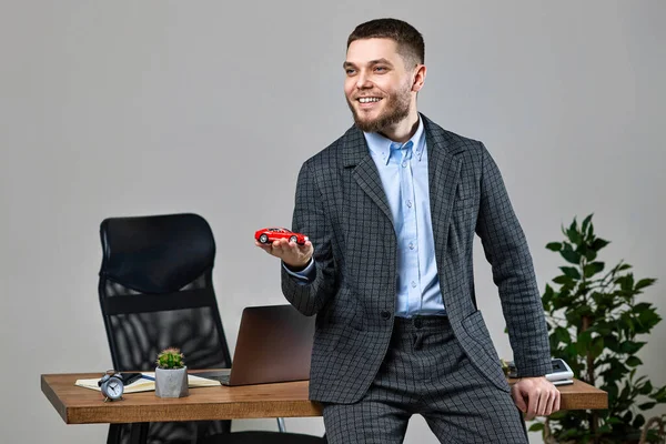 Successful Caucasian Cheerful Man Holding Toy Car While Standing Desk — Stock Photo, Image
