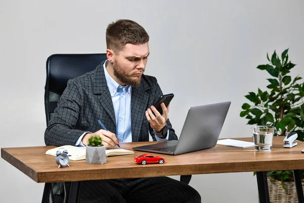 manager man working with laptop and holding smartphone. solutions for business development