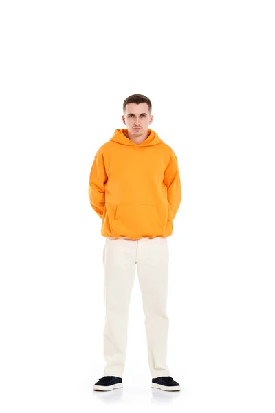 thoughtful young man in blank sweatshirt with space for your logo or design on white background. . Full length