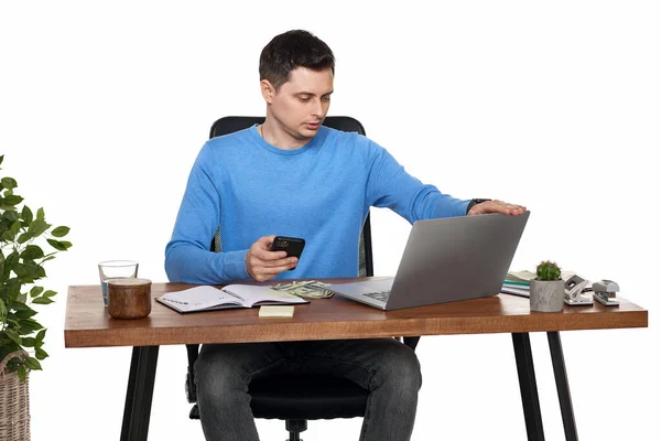 stock image handsome businessman working with laptop and using smartphone on white background