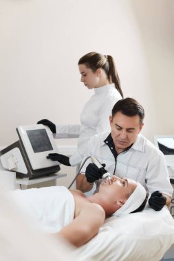 Estetik tıp kliniğinde RF kaldırma prosedüründe yakışıklı bir adam.