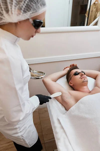 Young Man Protective Goggles Undergoes Procedure Arm Pit Laser Epilation — Stock Photo, Image