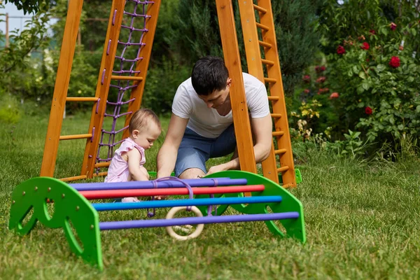 Little Child Girl Daughter Helps Her Father Collect Wooden Sports — Stock Photo, Image
