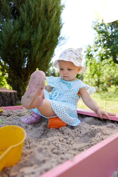 stock image cute little girl playing in sand in sandbox with various toys on outdoor playground