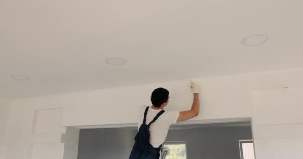Repairman Man Uniform Painting Wall White Color Brushes While Renovating — Stock Video