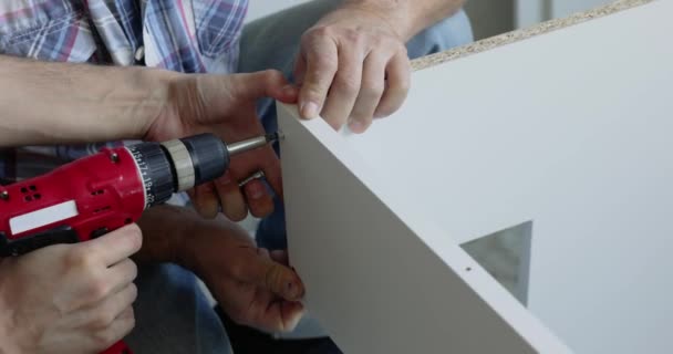 Carpenter Man Screws White Furniture Parts Using Electric Screwdriver — Stock Video
