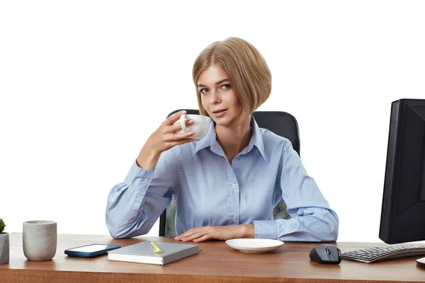 beautiful blonde business woman using PC computer, drinking coffee in the office