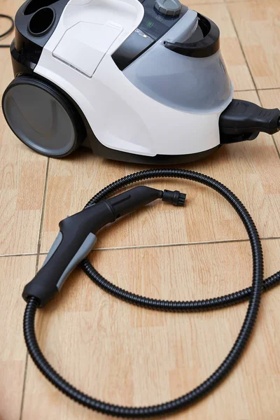 Professional cleaning steam generator on the kitchen floor. Home cleaning.