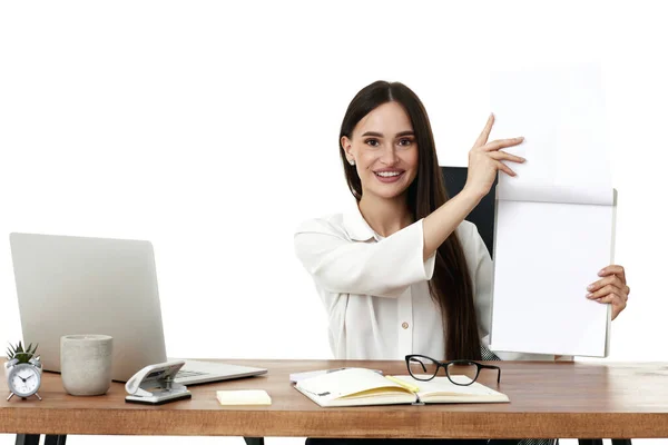 positive businesswoman showing empty clipboard in the office