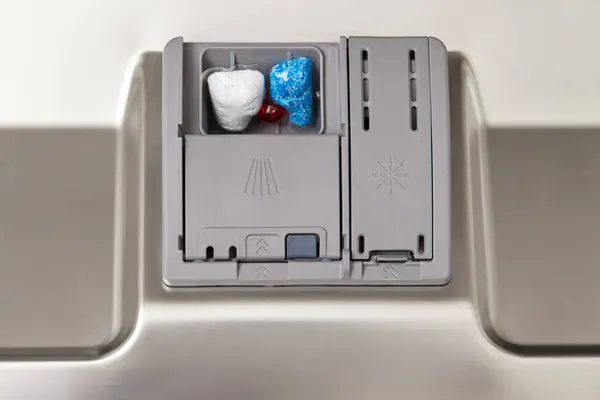 Dishwasher compartments for detergents with dishwasher tablet inside. close-up.