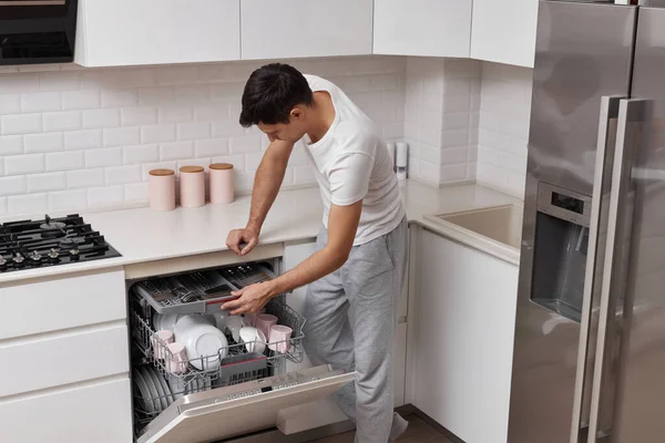 Handsome Positive Man Putting Plates Dishwasher Machine Kitchen — Stock Photo, Image