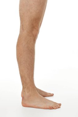 Barefoot male legs on white background. Body care concept. clipart