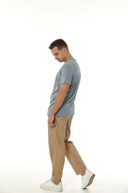 Beyaz arka planda hayal kırıklığına uğramış genç bir adam. Üzüntü