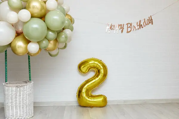 Many white green and gold balloons and Happy Birthday golden texts and 2 gold balloon , party even