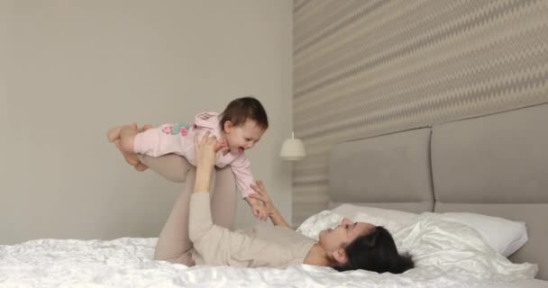 Happy Caucasian Mother Raising Laughing Cute Baby Playing Together Bedroom — Stock Video