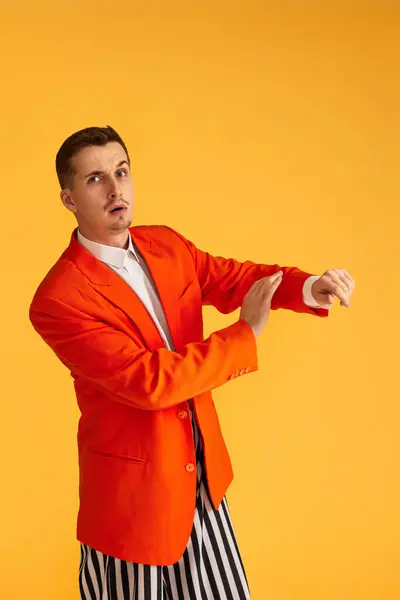 Cheerful Funny Young Man Orange Jacket Striped Pants Yellow Background — Stock Photo, Image