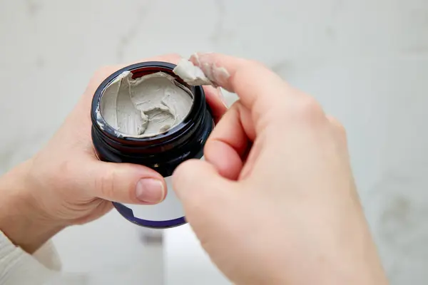 Female Hand Takes Clay Face Mask Jar Home Spa Stock Picture