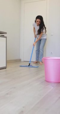 Kıvırcık ev kadını odayı temizler ve yerleri siler, günlük temizlik yapar.