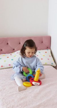 Küçük çocuk renkli piramitlerle evde oynamaya başladı.