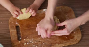 Anne ve çocuk hamur yoğuruyorlar mutfakta, yakın plan.