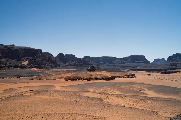 stock image view in the Sahara desert of Tadrart rouge tassili najer in Djanet City  ,Algeria.colorful orange sand, rocky mountains