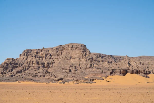 stock image view in the Sahara desert of Tadrart rouge tassili najer in Djanet City  ,Algeria.colorful orange sand, rocky mountains