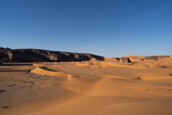 stock image view in the Sahara desert of Tadrart rouge tassili najer in Djanet City  ,Algeria.colorful orange sand, rocky mountains