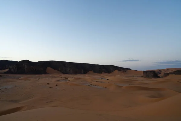 stock image view in the Sahara desert of Tadrart rouge tassili najer in Djanet City  ,Algeria.colorful orange sand, rocky mountains