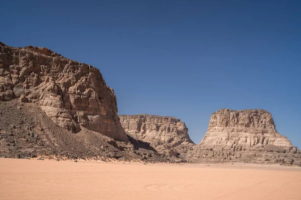 stock image view in the Sahara desert of Tadrart rouge tassili najer in Djanet City  ,Algeria.colorful orange sand, rocky mountains