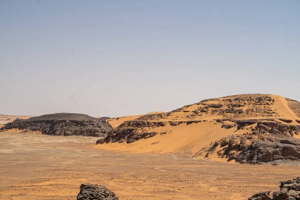 stock image view in the Sahara desert of Tadrart rouge tassili najer in Djanet City  ,Algeria.colorful orange sand, rocky mountains