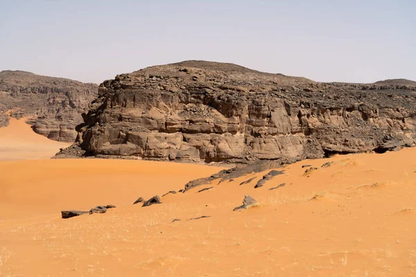 stock image view in the Sahara desert of Tadrart rouge tassili najer in Djanet City  ,Algeria.colorful orange sand, rocky mountains