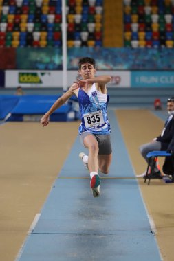 ISTANBUL, TURKEY - JANUARY 16, 2022: Undefined athlete triple jumping during Turkish Athletic Federation Indoor Athletics Record Attempt Races