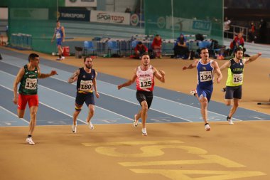 ISTANBUL, TURKEY - MARCH 05, 2022: Athletes running 60 metres during Balkan Athletics Indoor Championships in Atakoy Athletics Arena