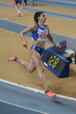 ISTANBUL, TURKEY - MARCH 05, 2022: Undefined athlete running 4x400 metres relay during Balkan Athletics Indoor Championships in Atakoy Athletics Arena