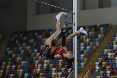 ISTANBUL, TURKEY - MARCH 05, 2022: Undefined athlete pole vaulting during Balkan Athletics Indoor Championships in Atakoy Athletics Arena