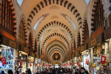 ISTANBUL, TURKIYE - FEBRUARY 11, 2023: People shopping at Spice Bazaar. The Spice Bazaar is one of the oldest bazaar in Istanbul.