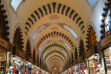 ISTANBUL, TURKIYE - FEBRUARY 11, 2023: People shopping at Spice Bazaar. The Spice Bazaar is one of the oldest bazaar in Istanbul.