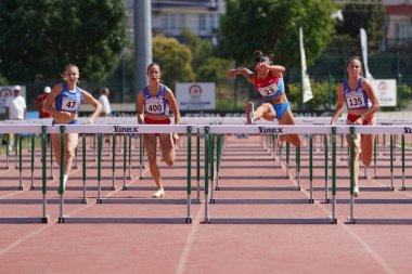 DENIZLI, TURKIYE - 17 Temmuz 2022: Balkan Atletizm Şampiyonası sırasında Denizli Albayrak Atletizm Pisti 'nde 100 metre engelli koşan sporcular