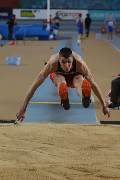 ISTANBUL, TURKEY - MARCH 05, 2022: Undefined athlete long jumping during Balkan Athletics Indoor Championships in Atakoy Athletics Arena