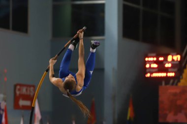 ISTANBUL, TURKEY - MARCH 05, 2022: Undefined athlete pole vaulting during Balkan Athletics Indoor Championships in Atakoy Athletics Arena